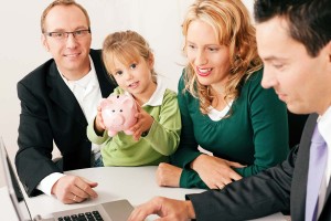 couple with child holding piggybank receiving financial planning advice