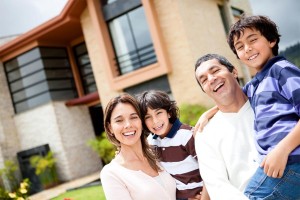 Australian Family Smiling Out Front of House